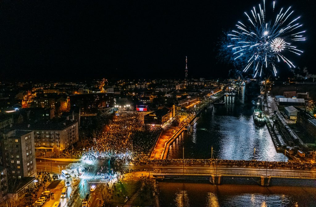 Skats no gaisa naktī, uguņošana, kanāls, skatītāju pūlis un skatuve